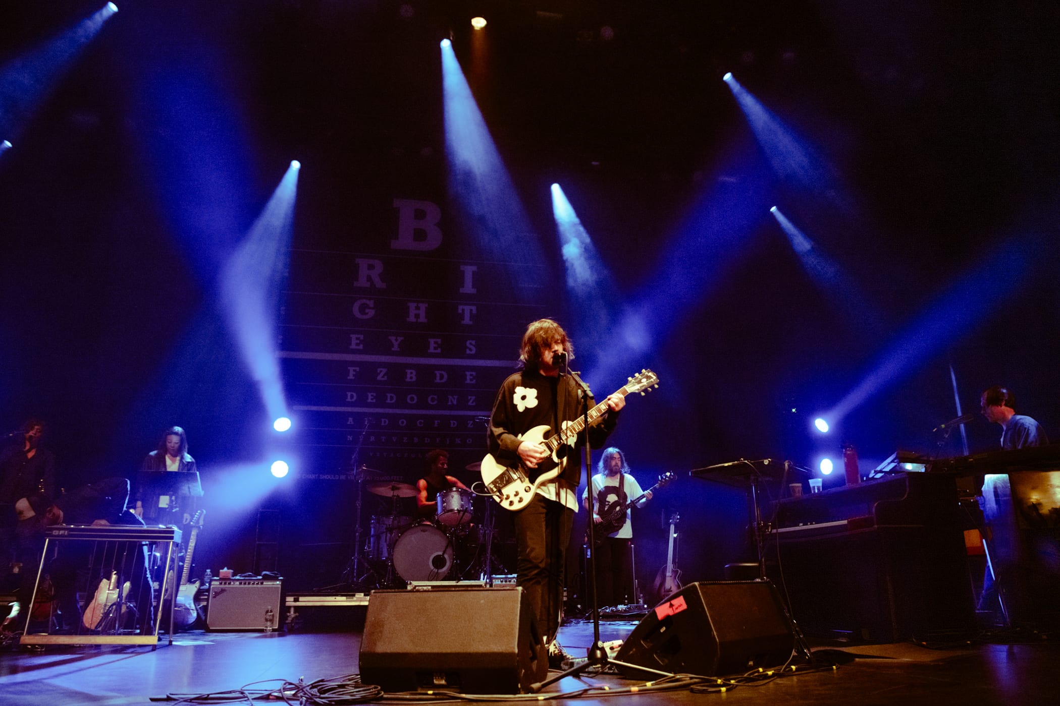 person on stage playing guitar