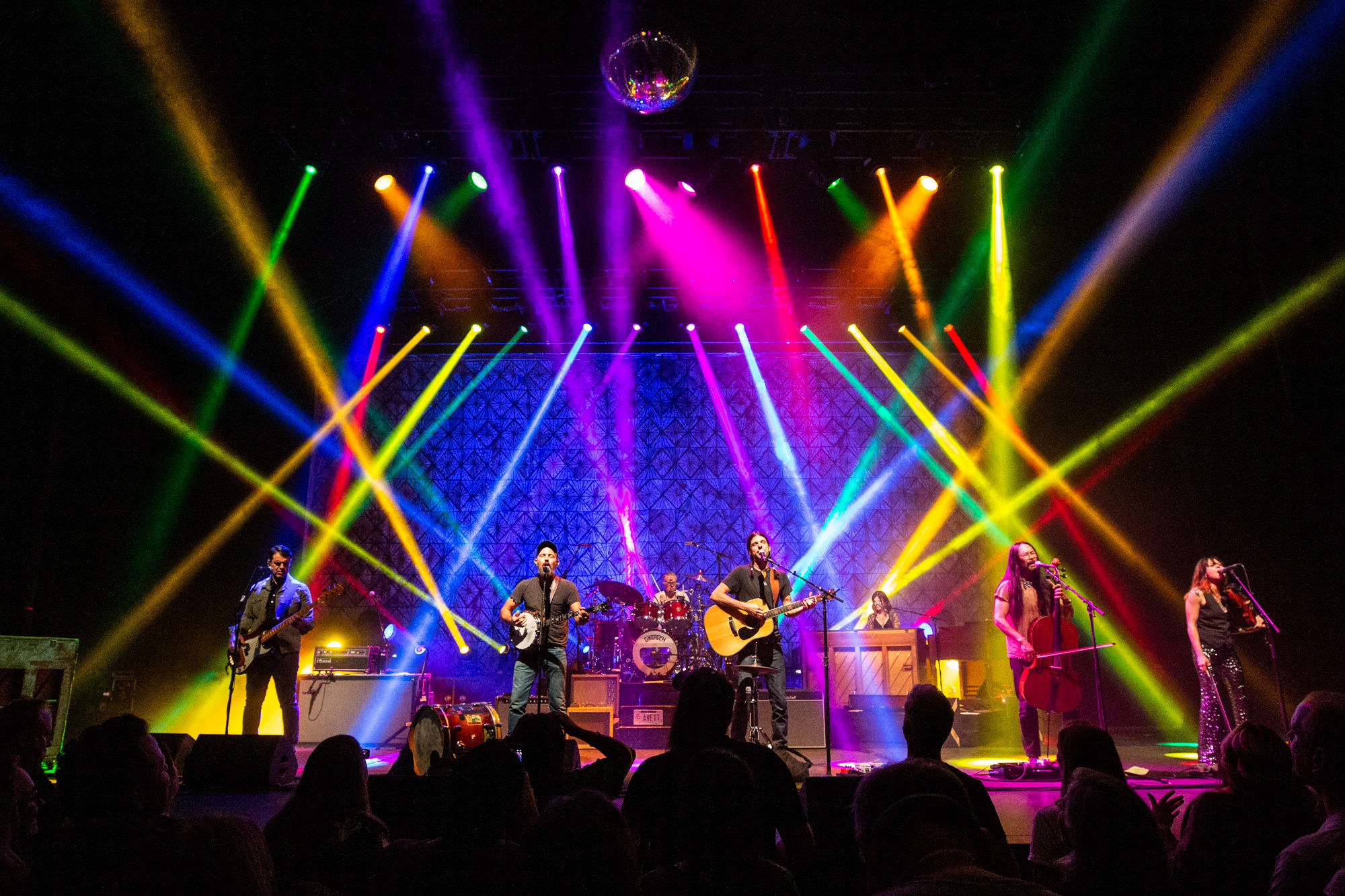 event on stage with some audience members and multi color lights