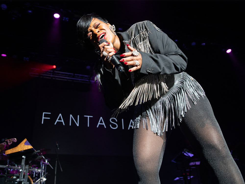 A performance shot of singer Fantasia performing up close.