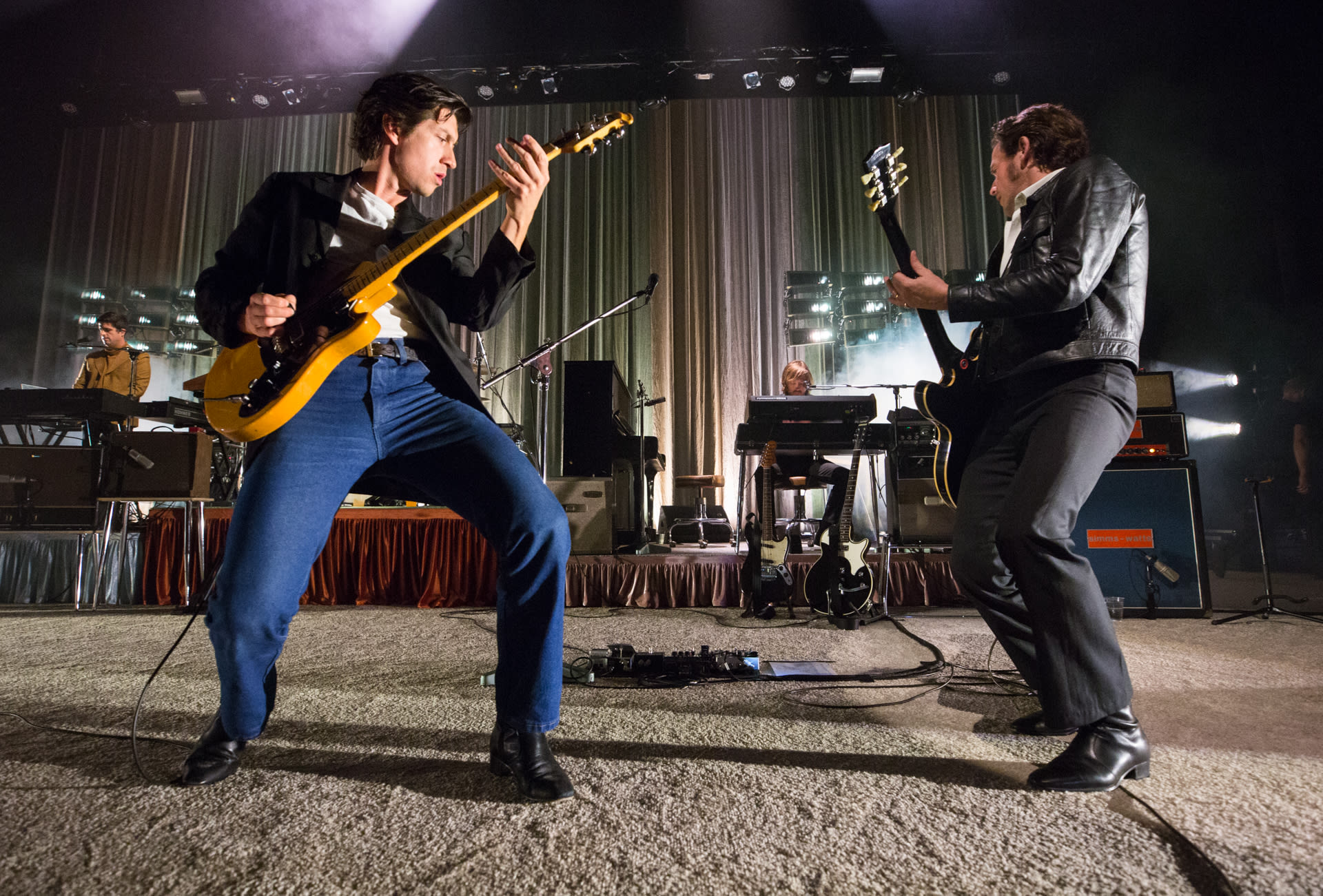 two men playing guitars