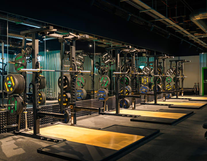 The lifting hall at XF Manchester, squat racks in a row