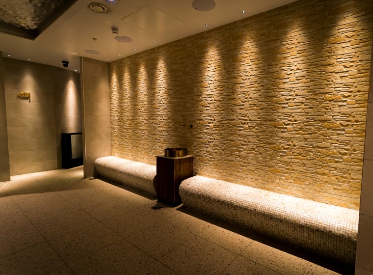 The spa corridor at XF Manchester in textured stone