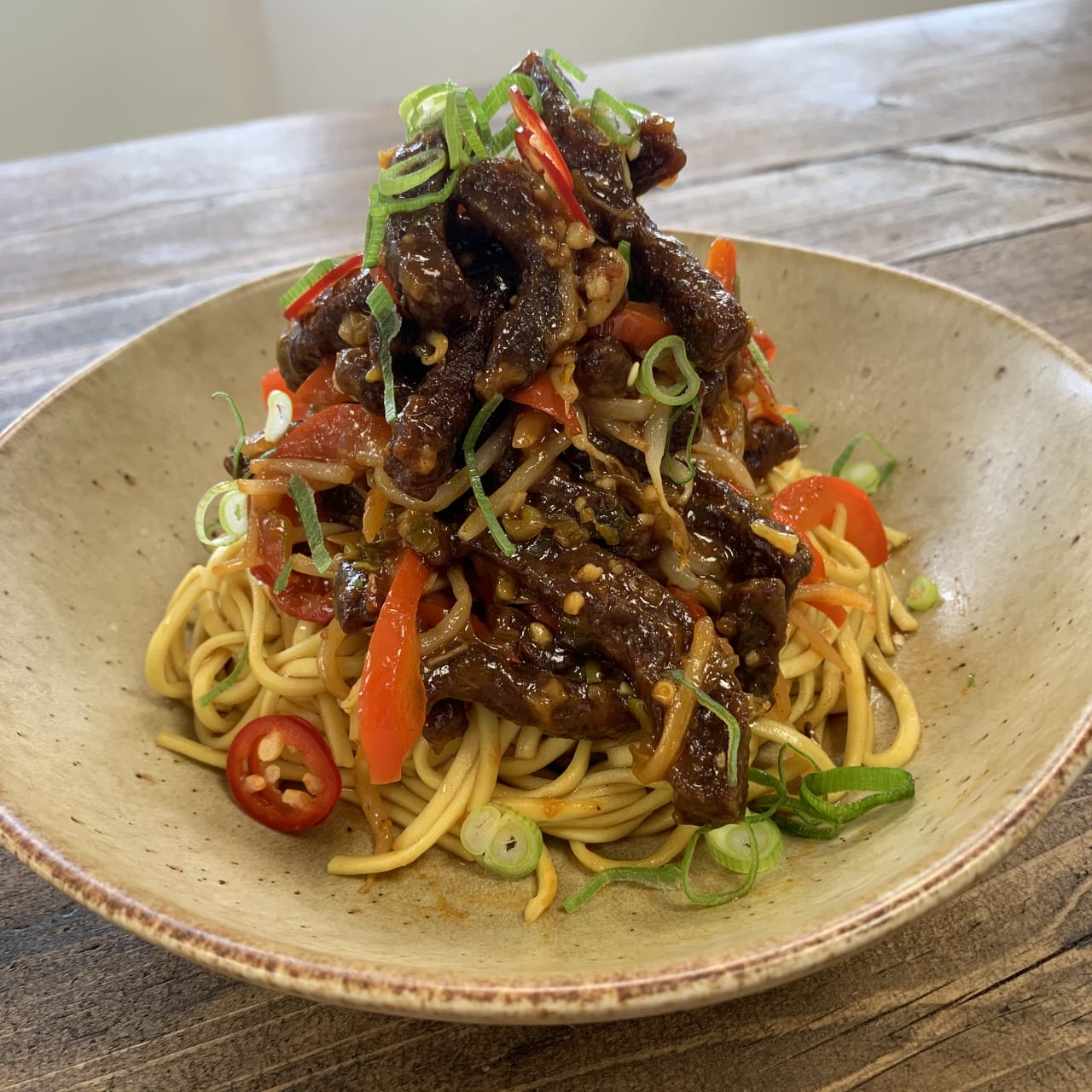 Crispy Chilli Beef served with noodles