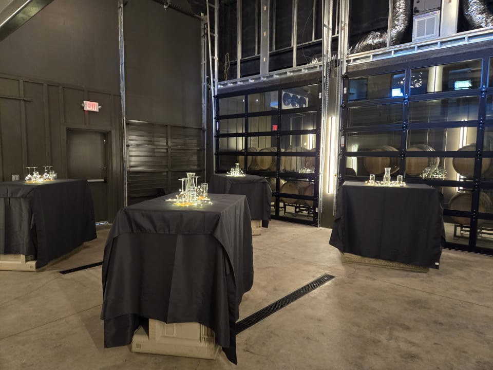 The Barrel Room set up for a live music night, high-top tables and decanters