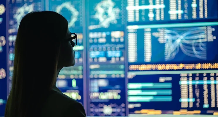 The businesswoman in glasses standing near the display