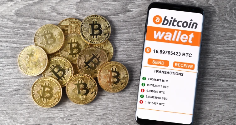 physical coins with bitcoin logo with iphone