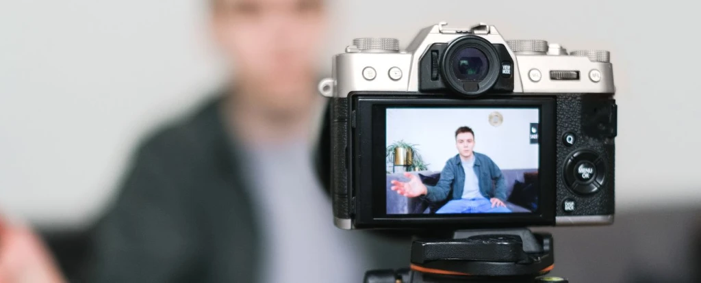 Man sitting in front of camera recording a video of himself