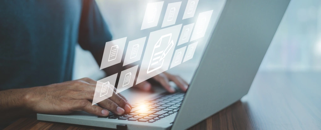 A person typing on a laptop with floating digital document icons, symbolizing data management, cloud computing, or digital file storage.