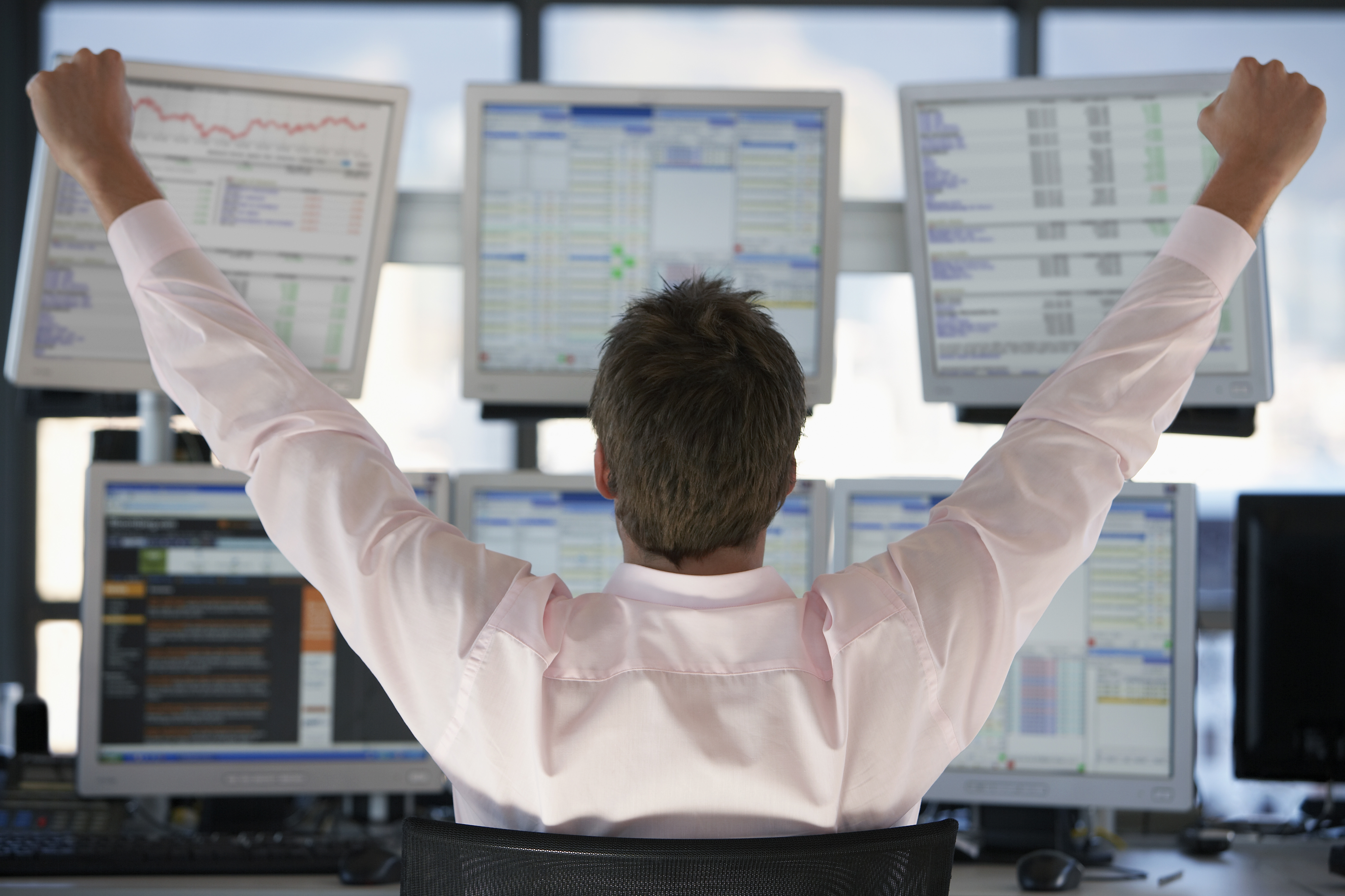 Happy Hedge Fund Trader looking at screens
