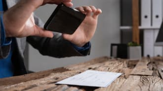 Man taking a shot of a receipt using his smartphone