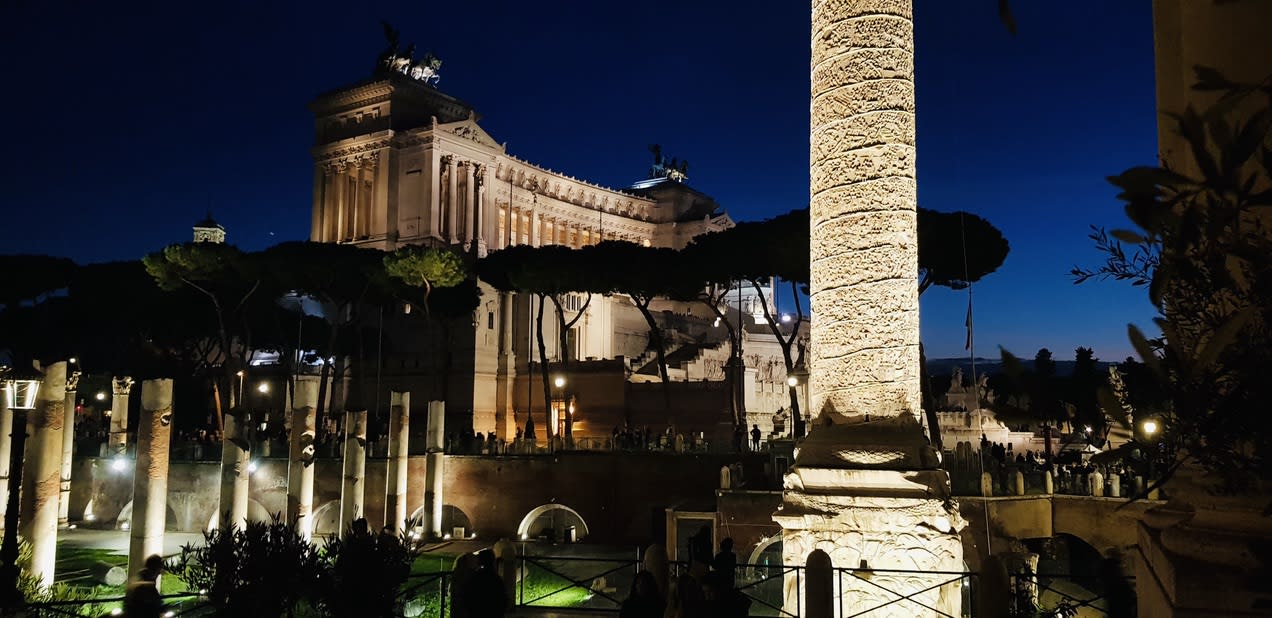 A favorite scene unfolds at night: the Altare della Patria in Rome, [Italy](/destinations/italy), illuminated with glowing columns and trees in the foreground, capturing a full-length view of architectural splendor. This enchanting setting becomes even more magical during a gay New Year's Eve celebration, as locals and visitors alike gather to welcome the new year in joyous unity.