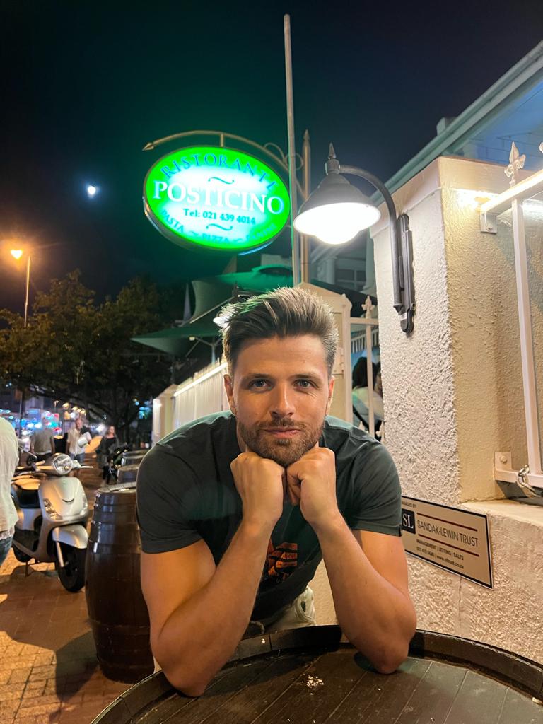 Ryan in front of a pizza place