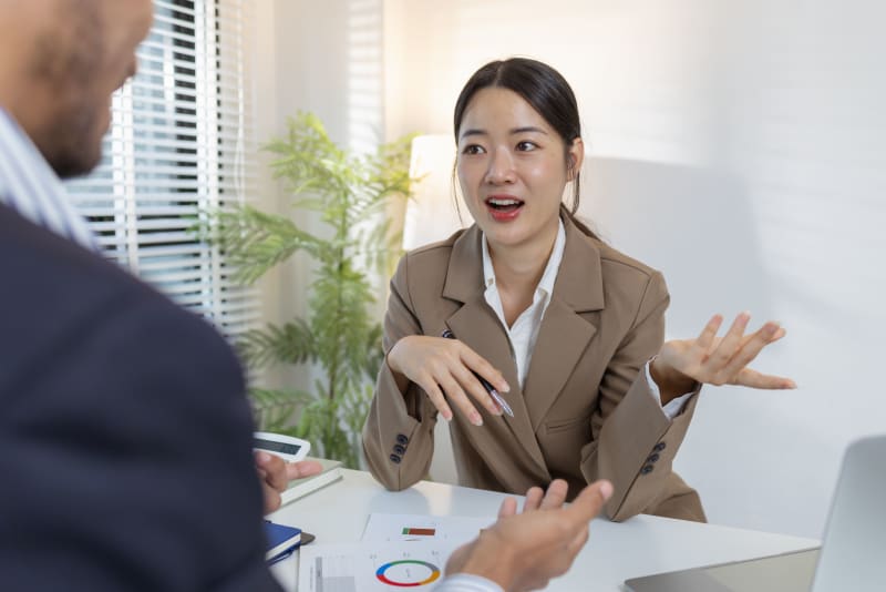 Two business professionals discussing financial documents