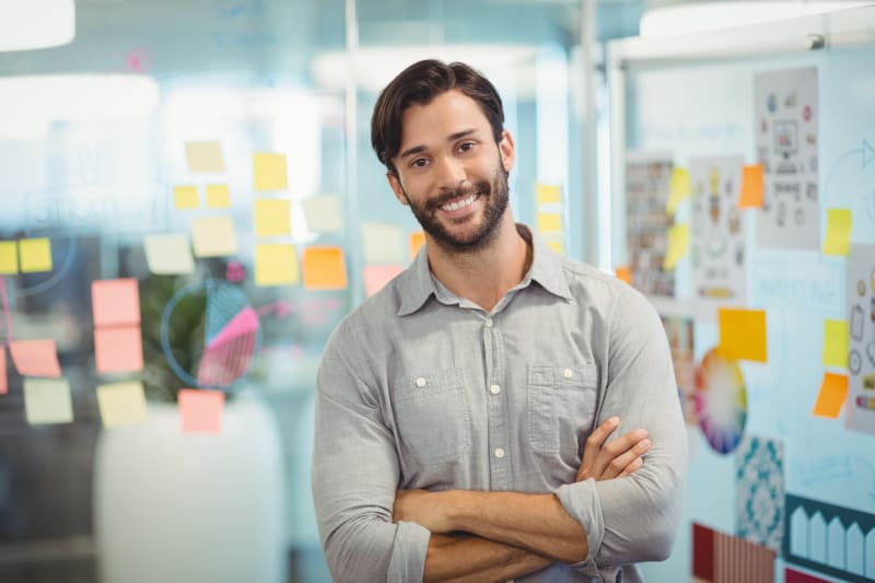 Male business executive standing with arms crossed