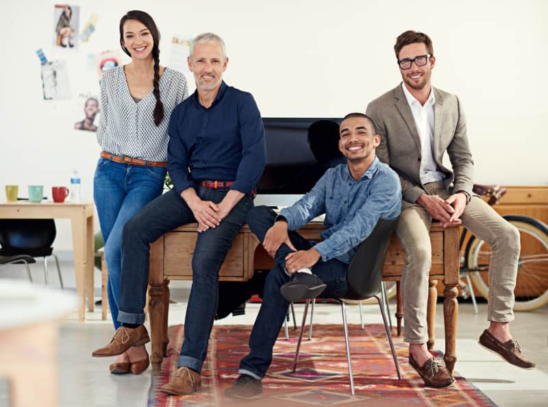 Smiling colleagues posing together in modern office