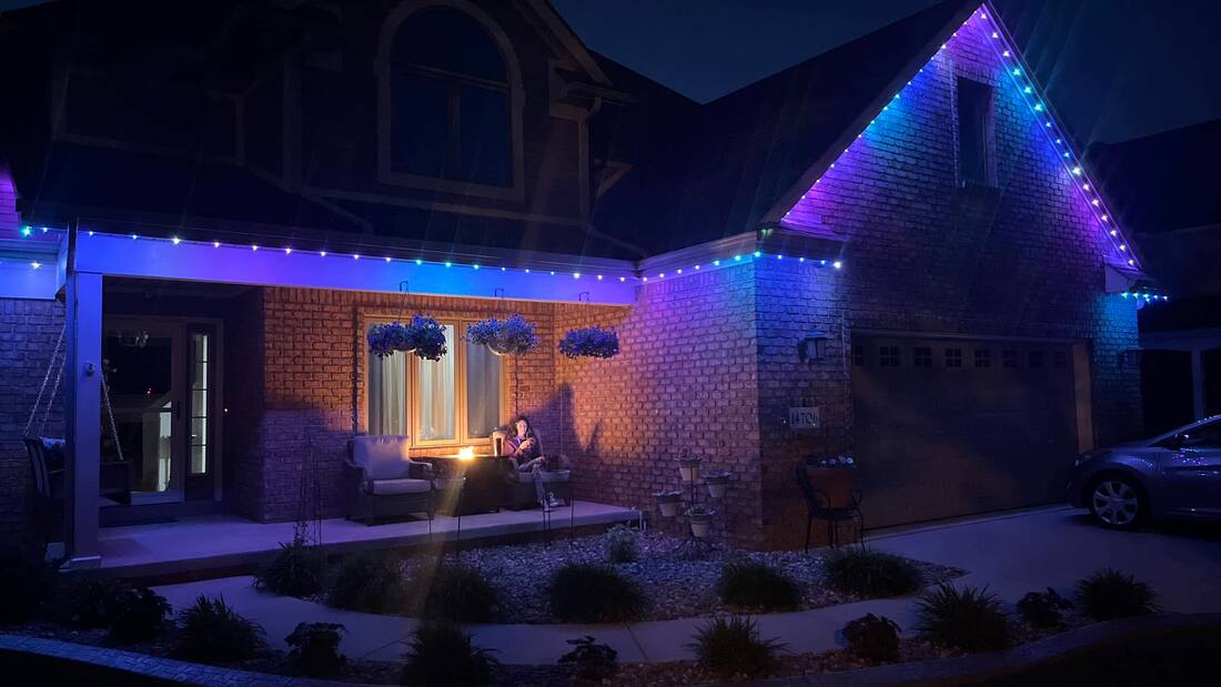 Trimlight casting purple light on driveway