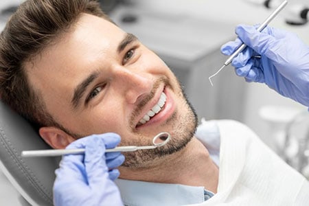 Dentist examining patient