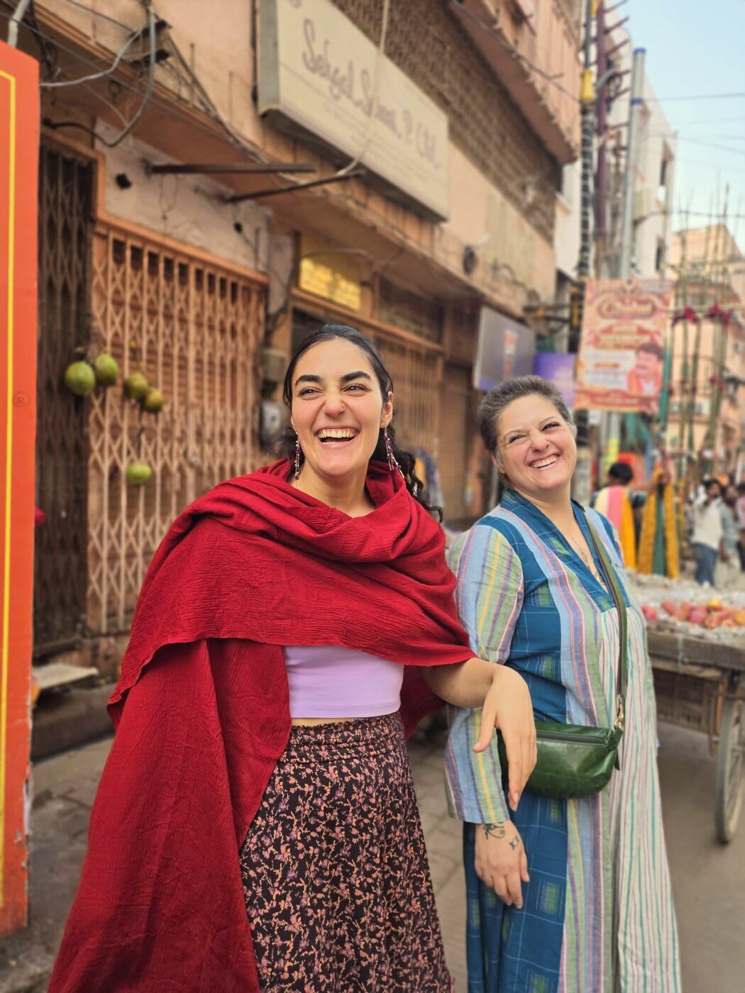 Two of us laughing in a colourful old lane of Kashi