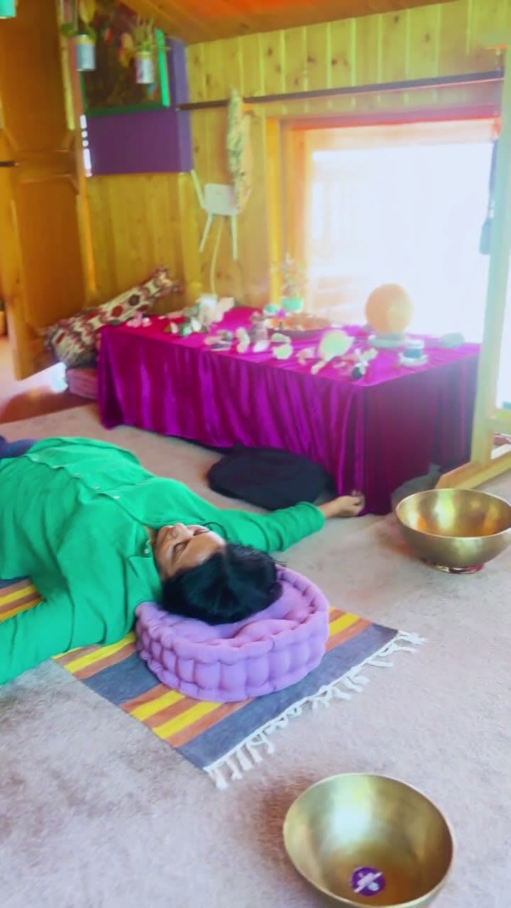 The healing space at Sehar, with singing bowls, a gong and a guest resting on a cushion