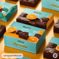 Boxes with teal and orange designs featuring chocolate brownies and oranges