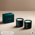 Teal candle jars with matching boxes on beige surface