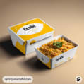 White and yellow meal box with an open dish of food on beige background.