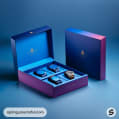 Luxurious gradient blue and purple watch box set with four watches, displayed on a blue background.