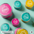 Round tins in teal, pink, and yellow with floral motifs.