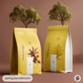 Yellow standing pouches with leaf graphics and trees in the background.