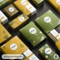 Assorted green and yellow tea boxes with floral patterns.