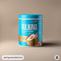 Blue BULKING protein powder jar on beige background.