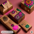 Various cardboard boxes with floral designs and vibrant colors on a pink background.