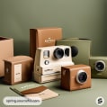 Collection of cameras with minimalist packaging in muted colors.