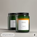 Two green glass candles with orange labels.