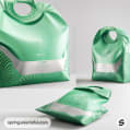 Green sculpted resealable pouch with silver accents, featuring a geometric design and handle.