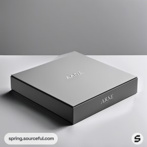 Single black square box with minimalist branding on gray surface.