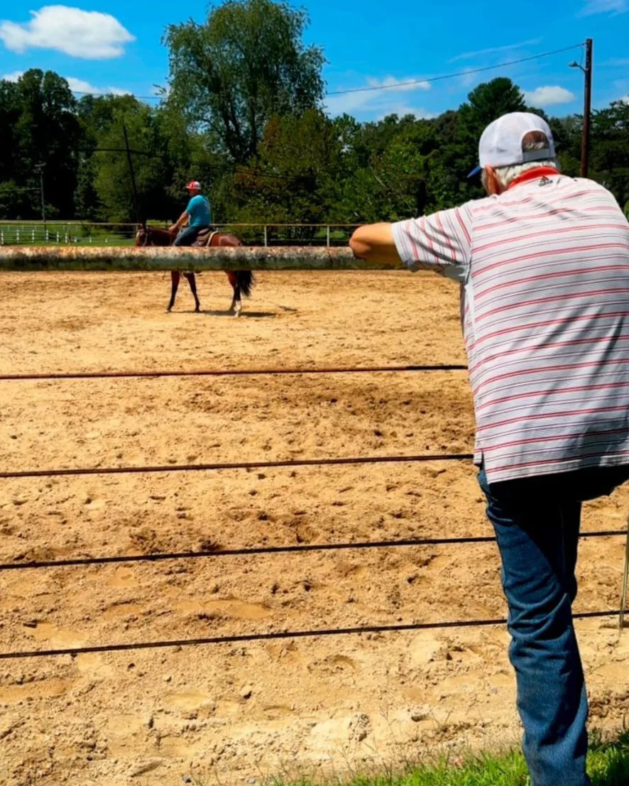 Taft Dickerson riding while his father Donnie watches