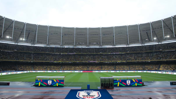 The inside of the stadium during a Mitsubishi Electric Cup match, with full stands and seats.
