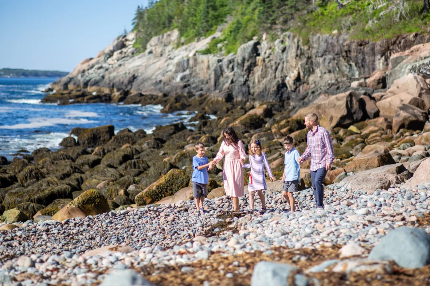 The Schwan family on a rocky coastal beach