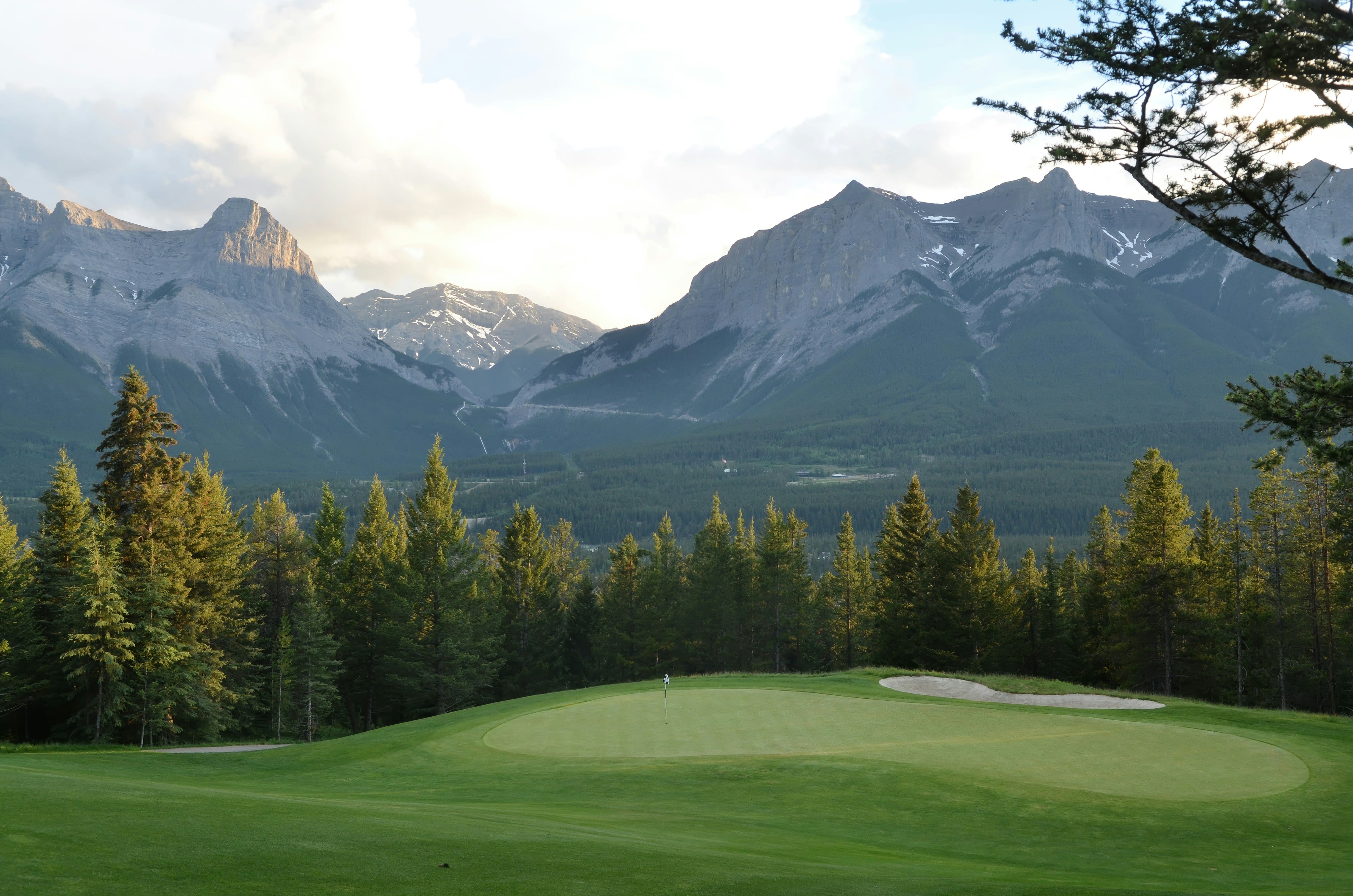 Golf course green with Canadian Rocky Mountain backdrop