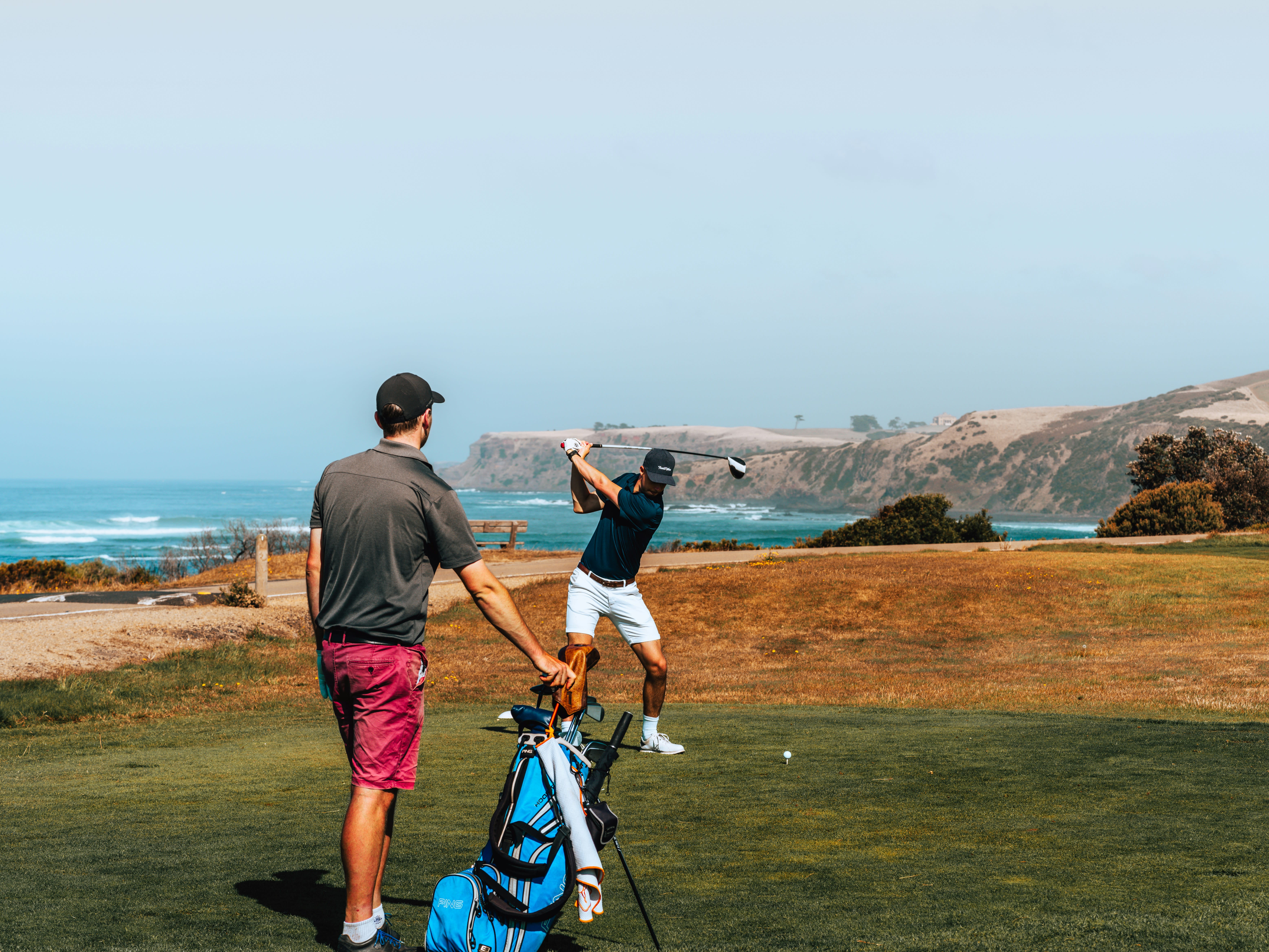 Two golfers on a clifftop coastal course