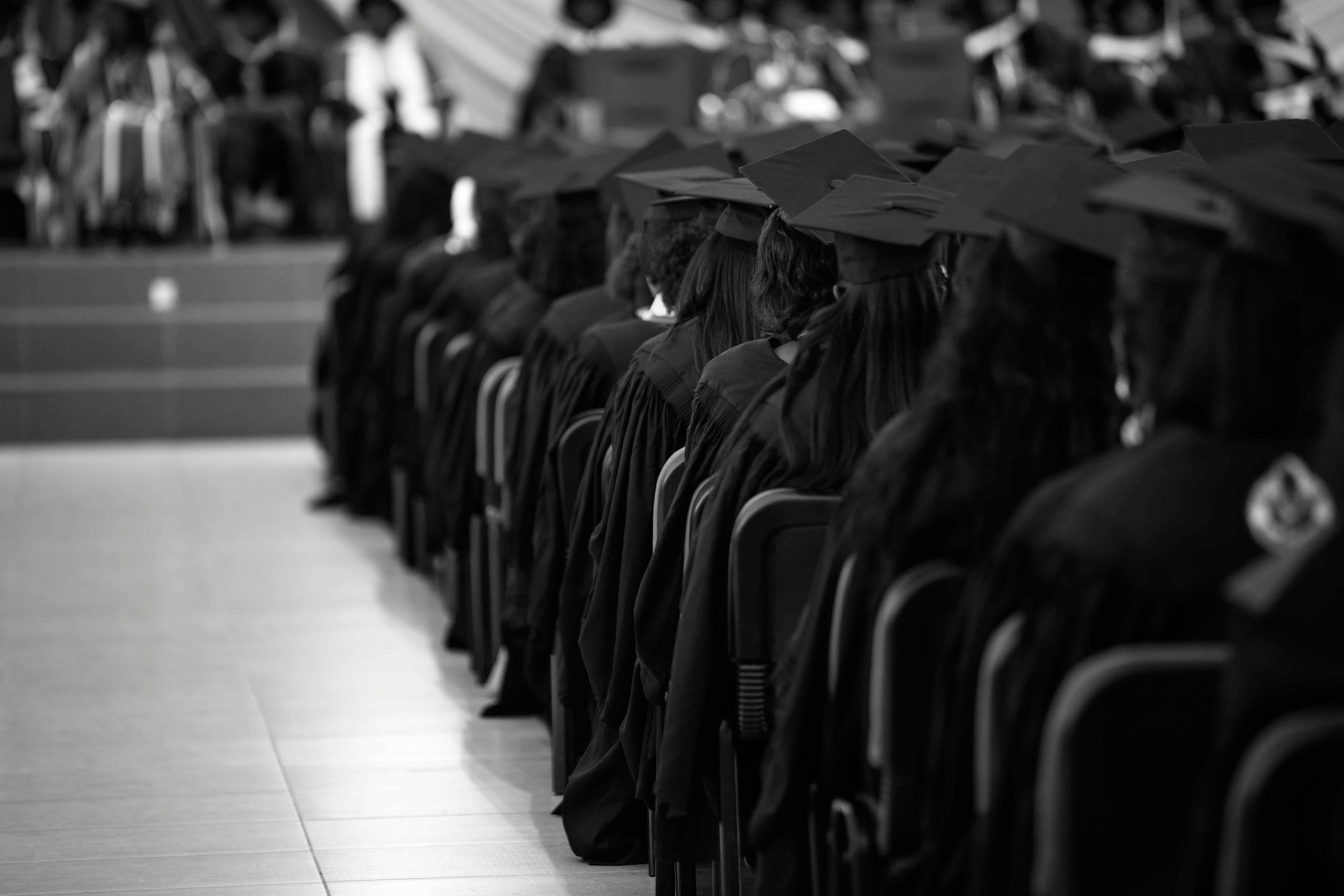Graduates in caps and gowns at a commencement ceremony