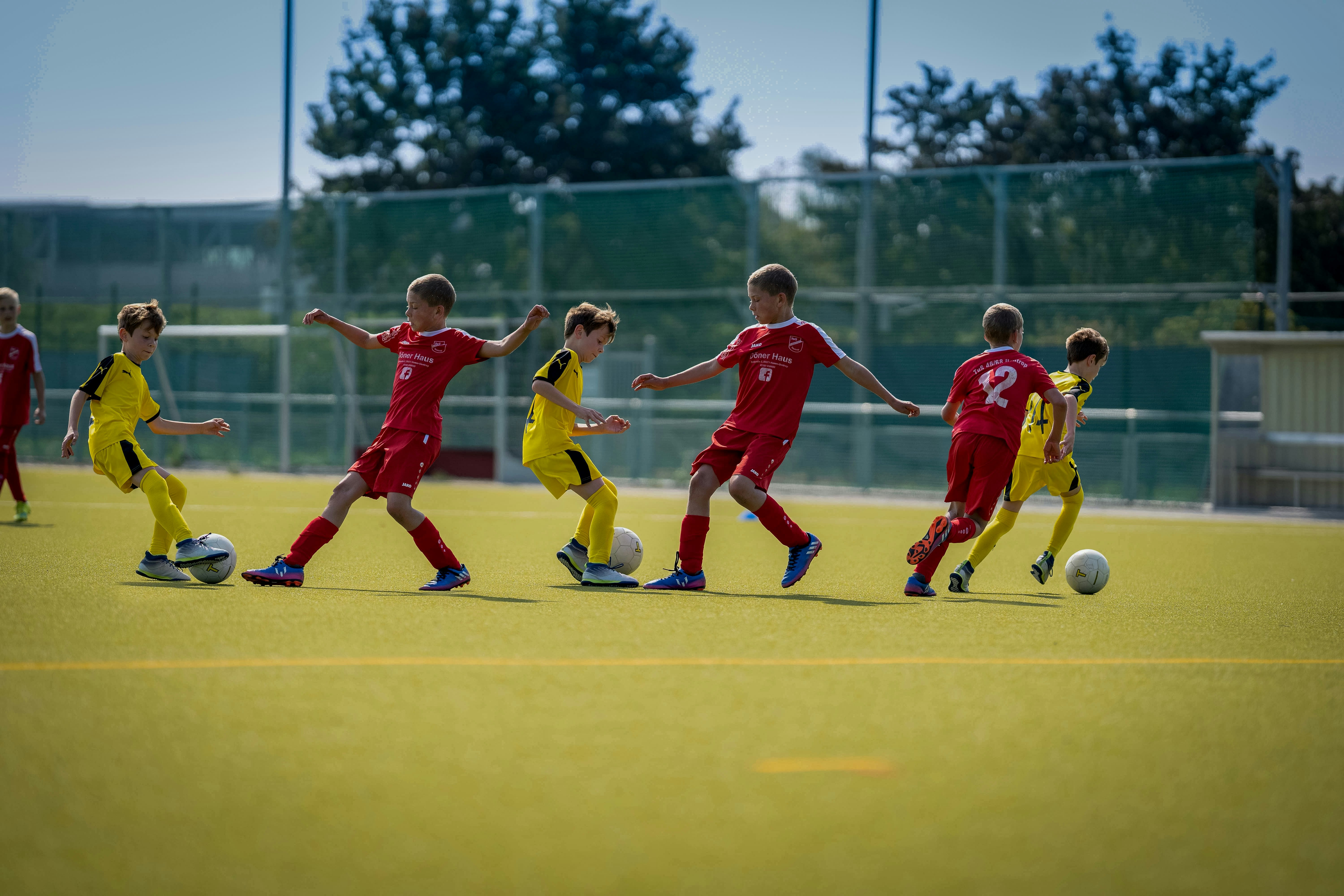 Youth players in a competitive training session on artificial turf
