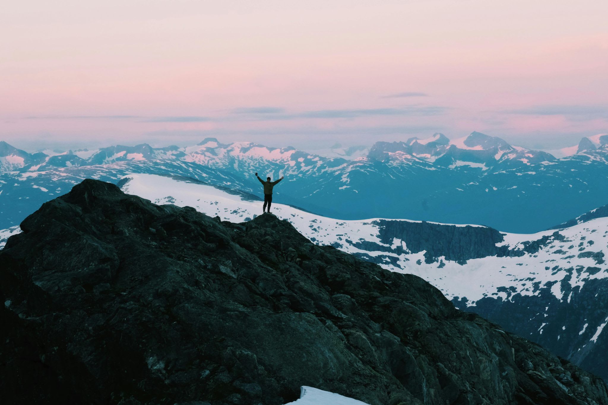 Snow-covered mountain summit at sunrise