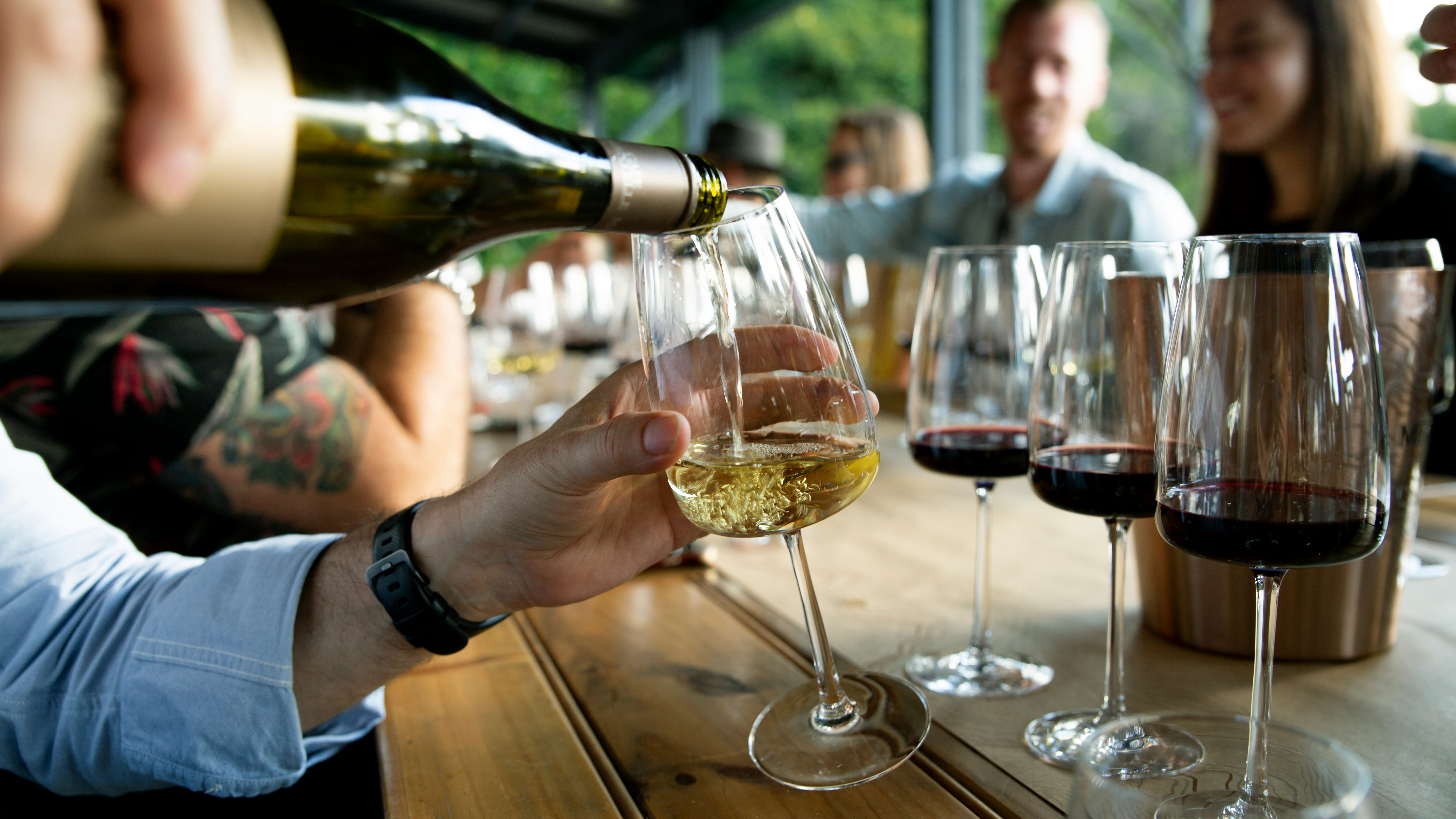 Sommelier pouring wine at a private tasting table