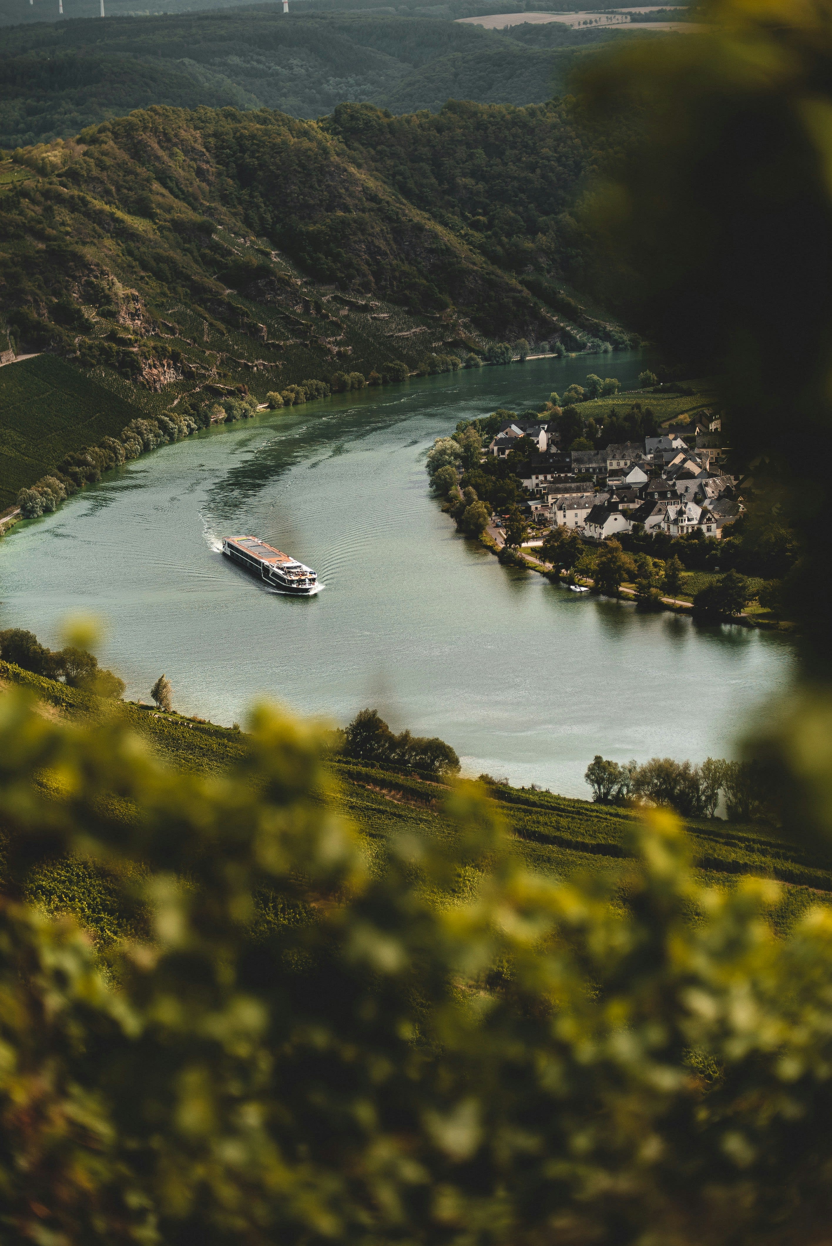 River cruise ship on the Moselle with vineyard hillsides on both banks
