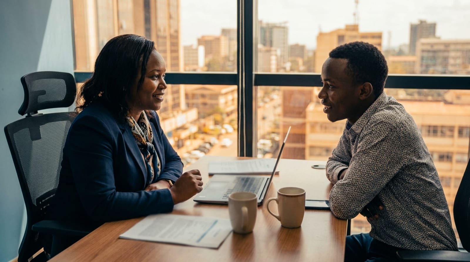 An Adel advisor sitting with a job seeker in the Nairobi office
