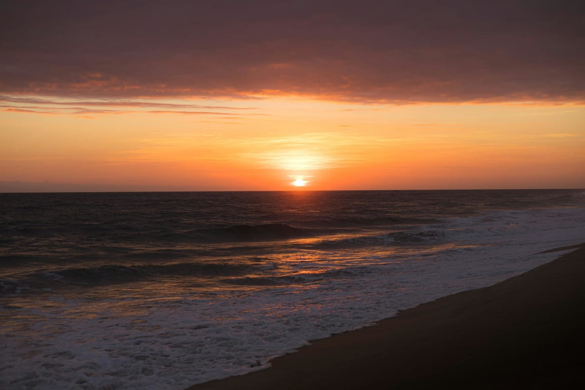 Sunset over the ocean with waves crashing at Puerto Escondido Oaxaca Mexico — cost of living 2026