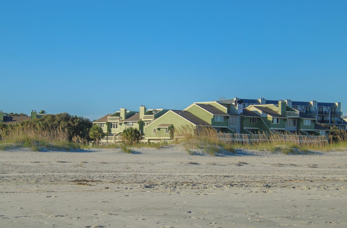 Beachfront condos under a blue sky near Zicatela, Puerto Escondido, Mexico — the property type most covered in this Zicatela real estate guide