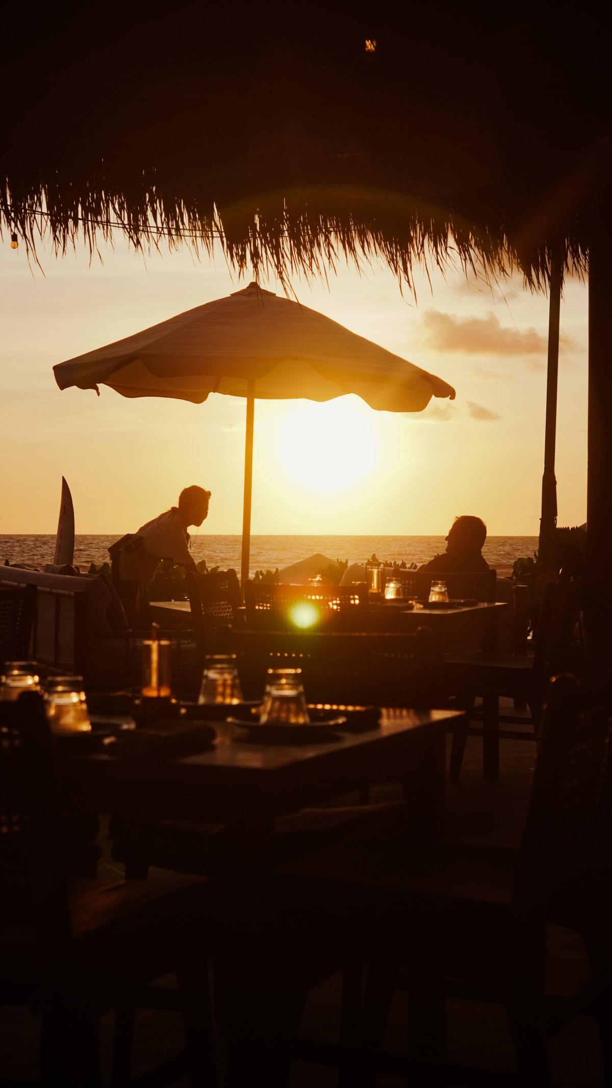 Sunset dining at a beachfront restaurant near Zicatela, Puerto Escondido, Mexico — the dining scene that supports rental demand in this Zicatela real estate guide